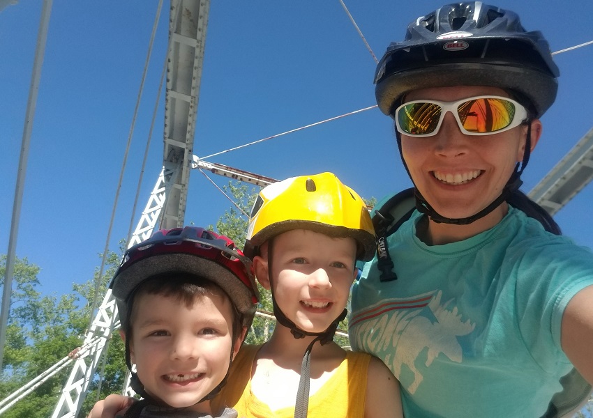 Heather and her two children, Quinton and Miles, at the Station Road Bridge along the Towpath Trail.